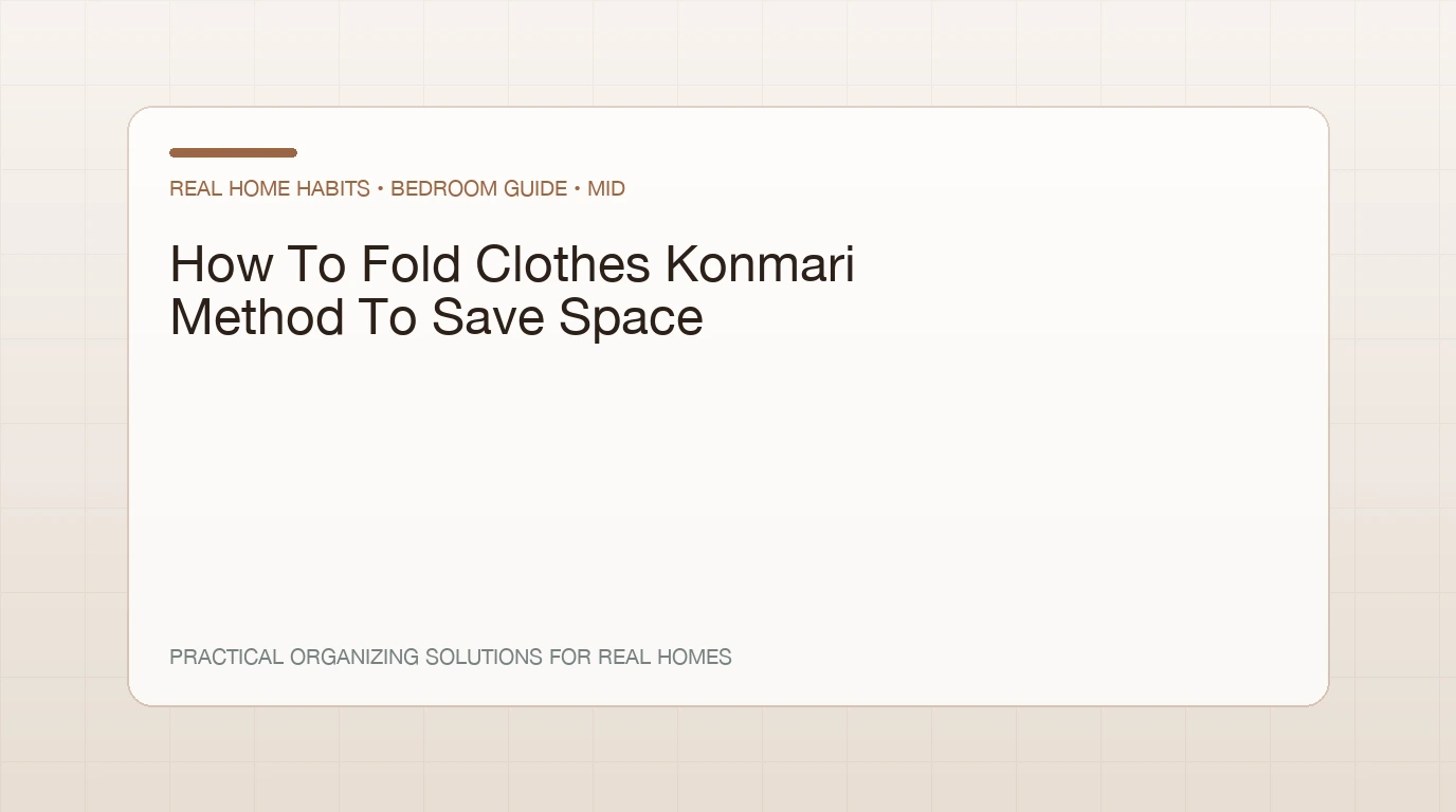 Hands folding a t-shirt into a small rectangle on a bed